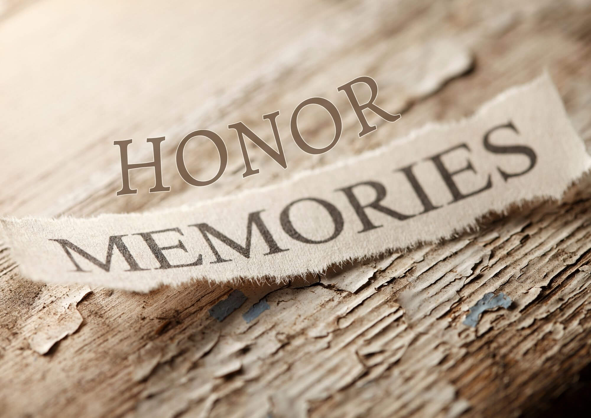 Rustic log with honor memories written across it